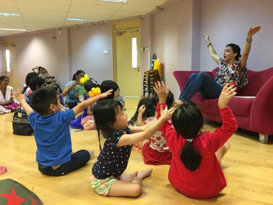 Storyteller Kamini gets the children to 'fly' with her!