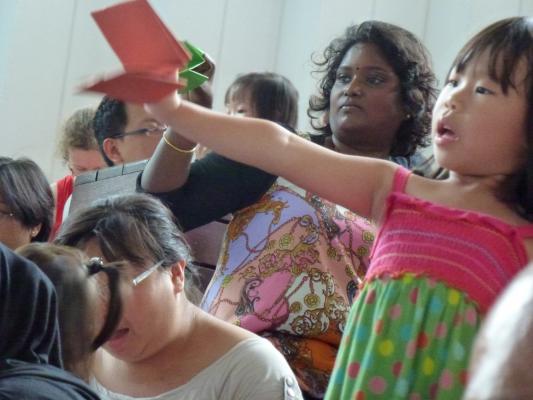 Audience learning to use their hand-made puppets